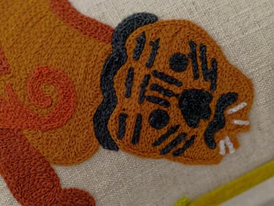 Vibrant stylised embroidery cushion