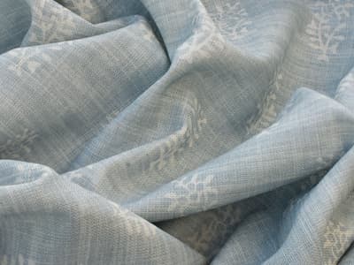 White botanical motif on soft blue