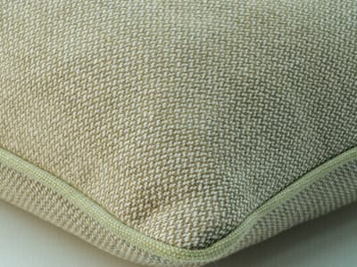 Cushion in muted pistachio weave