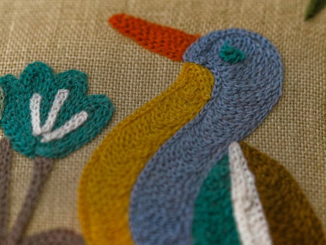 Vibrant woodland embroidery cushion