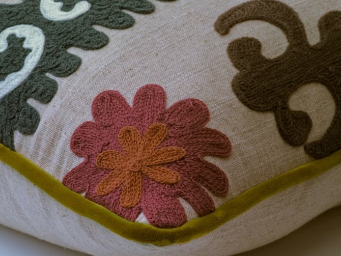 Vibrant stylised embroidery cushion