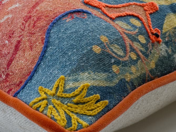 Vibrant embroidered landscape cushion