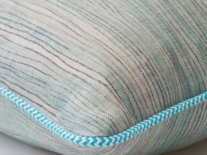 Cushion in soft blue brush marks
